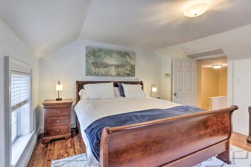 a bedroom with a bed and a dresser and a window at Townhome in Leesburg Historic District! in Leesburg