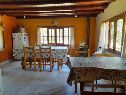 cocina y comedor con mesa y sillas en Hostel Casona Alameda en El Bolsón