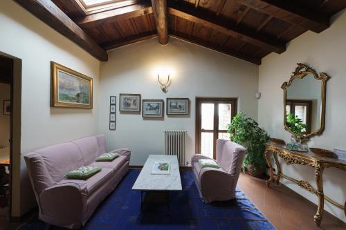 a living room with a couch and a table at Castello di Cernusco Lombardone in Cernusco Lombardone