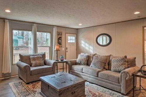 a living room with two couches and a table at Bayside Louisiana Vacation Rental with Dock! in Alliance