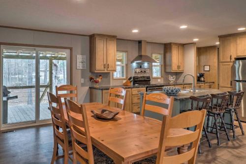 a kitchen with a wooden table and some chairs at Bayside Louisiana Vacation Rental with Dock! in Alliance