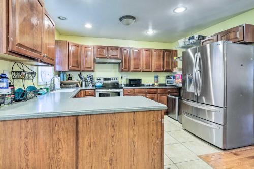 a kitchen with wooden cabinets and a stainless steel refrigerator at 5 Mi to National Mall Home in Washington DC in Washington, D.C.