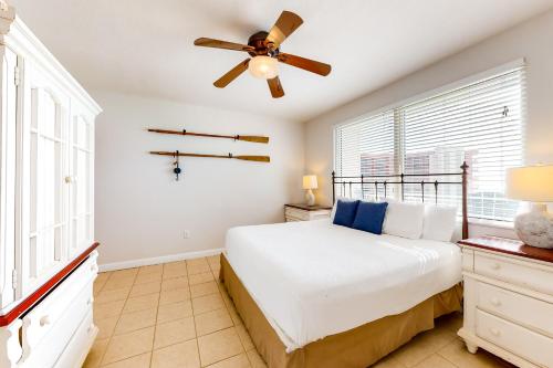 a bedroom with a bed and a ceiling fan at Shores of Panama 2011 in Panama City Beach