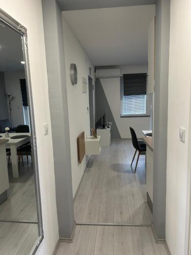 a hallway with a mirror and a dining room at Apartmani "Stari Grad - Samobor" in Samobor