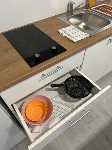 an open drawer in a kitchen with a sink at Apartmani "Stari Grad - Samobor" in Samobor