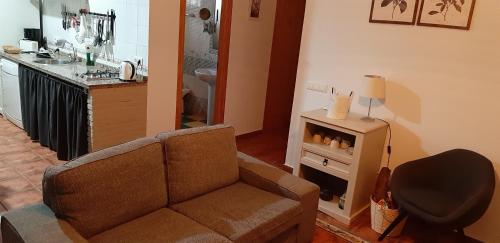 a living room with a couch and a stove at Cortijo Los Conquistadores in Lucena del Puerto