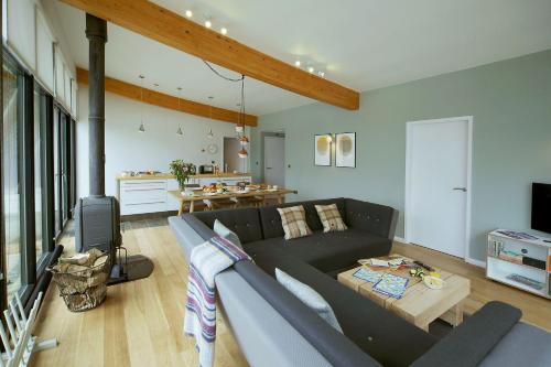 a living room with a couch and a table at Yorkshire Dales Lodge 6 by Together Travel - 3-Bed Family Retreat in Richmond