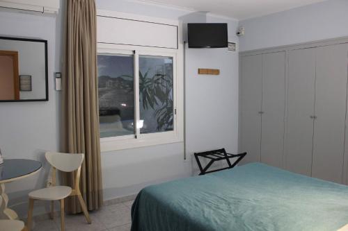 Hotel Alexandra Sitgesにあるベッド