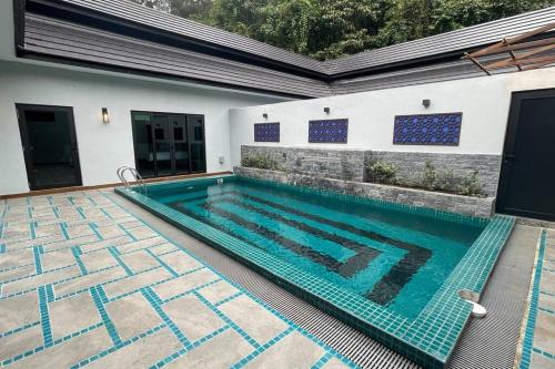 a swimming pool in a house at Charis Janda Baik Semi-D Villa 5:3 Bedrooms + Pool in Bentong