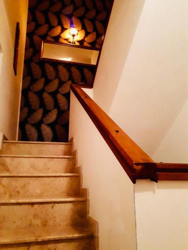a stairway with a light on the ceiling and a stair case at Iepurasul Sinaia in Sinaia