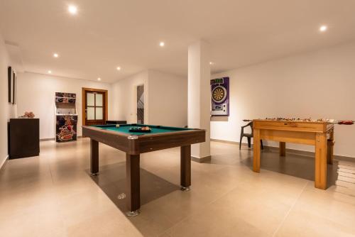 a living room with a pool table and a table at Chalet Tiro del Pichón I in Marbella