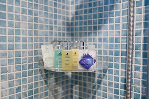estante de cristal en el baño con azulejos azules en Lemon house, en Éboli