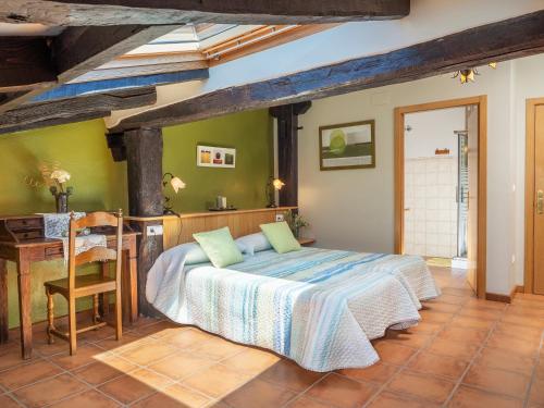 a bedroom with a bed and a table in it at Casa rural ALBIRENA in Arraiz-Orquín