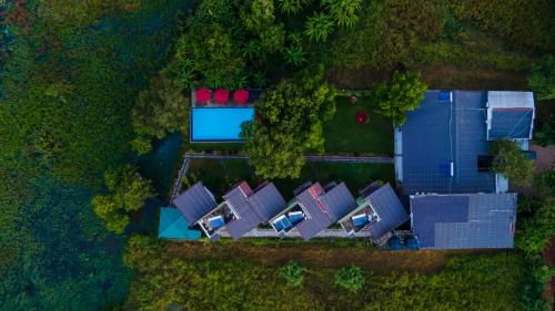 an overhead view of a house with a yard at Sigiriya Wewa Addara Hotel - Hotel By The Lake in Sigiriya