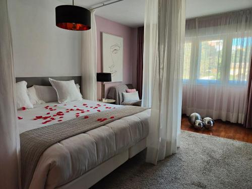 a bedroom with a bed with red roses on it at BYPILLOW Villa Lorena Adults Recommended in Málaga