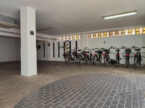 a room with a bunch of bikes lined up against a wall at BYPILLOW Villa Lorena Adults Recommended in Málaga