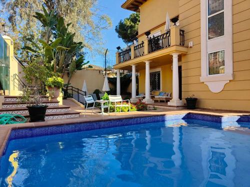 a swimming pool in front of a house at BYPILLOW Villa Lorena Adults Recommended in Málaga