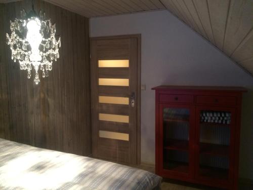 a bedroom with a bed and a chandelier at Voss- Myrkdalen Lodge in Vossestrand