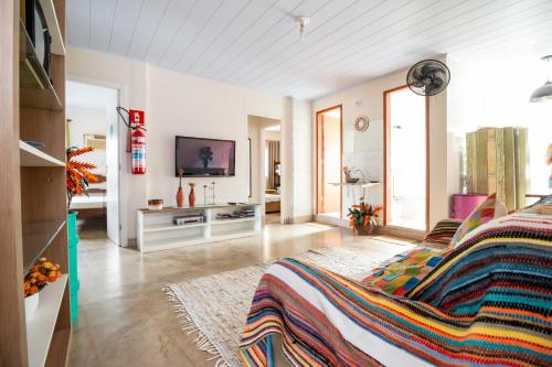 a living room with a bed and a tv at A Casa Morro do Moreno in Vila Velha