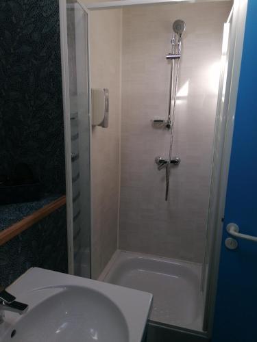 a bathroom with a shower and a sink and a tub at Chambres d'hôtes L'Astazou in Gavarnie