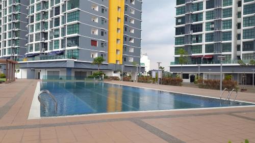 a swimming pool in a city with tall buildings at Vista Alam Studio in Shah Alam