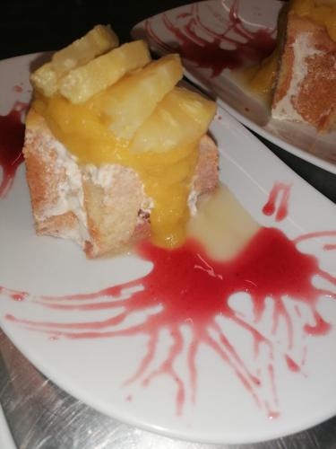 a white plate with a piece of cake and sauce at Chambres d'hôtes L'Astazou in Gavarnie