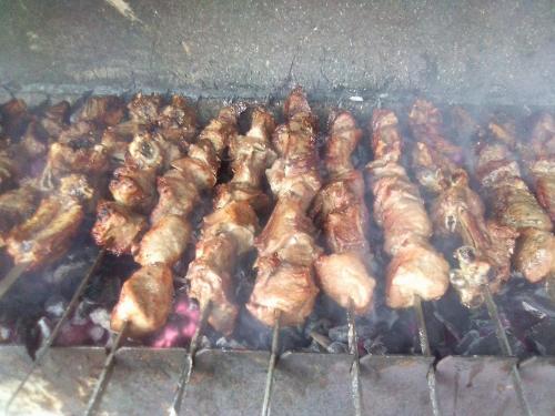 a bunch of meat cooking on a grill at Ushguli Terrace in Ushguli