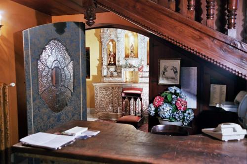 a room with a table and a altar with flowers at Hotel Castillo El Collado in Laguardia
