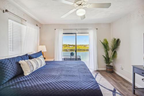 a bedroom with a bed and a large window at Bayshore Yacht & Tennis 409 - Premier in Clearwater Beach