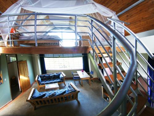 an overhead view of a spiral staircase in a living room at Yellow Haven Lodge in Kampala