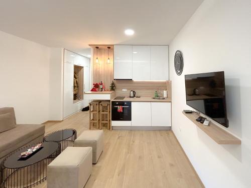 a living room with a couch and a kitchen at LanaMarija Apartment in Trebinje