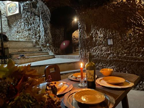 a table with a candle and a bottle of wine at Residenza Palazzo Fortuna - Boutique Hotel in Civita Castellana