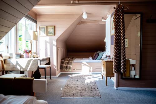 a bedroom with a bed and a table in a room at Fjærland Fjordstove Hotell - Huseby Hotelldrift AS in Fjarland