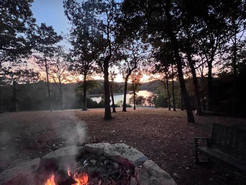a fire pit in a park with the sunset in the background at The Bavarian Village Resort in Branson