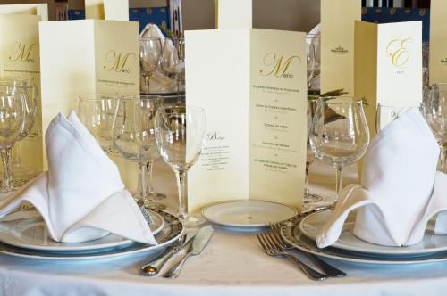 a table with wine glasses and napkins on it at Parador de Ferrol in Ferrol