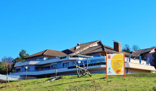a building with a sign in front of it at VVF Lac Léman Évian-les-Bains in Évian-les-Bains