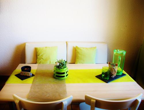 a table with a bed in the corner of a room at VVF Lac Léman Évian-les-Bains in Évian-les-Bains