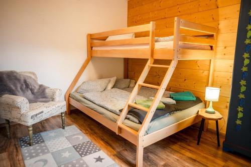 a bunk bed in a room with a ladder at Apartments am See in Brienz