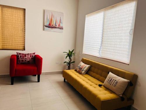 a living room with a couch and a red chair at Casa SOL #222, para 6 personas in La Paz