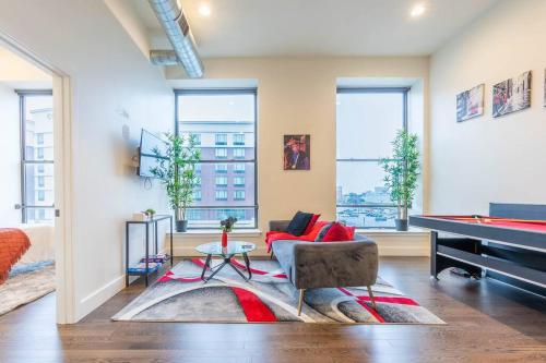 a living room with a pool table and a couch at 40 OFF Queen beds FREE Parking by American Dream in Newark