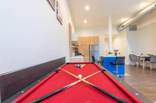 a pool table in the middle of a room at Downtown Beauty mins to Airport+FREE Parking+Games in Newark