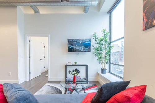 a living room with a couch and a large window at 40 OFF Queen beds FREE Parking by American Dream in Newark