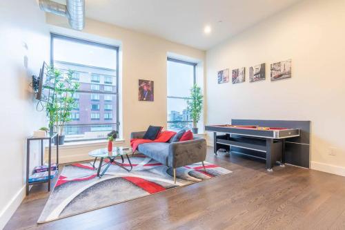 a living room with a couch and a pool table at 40 OFF Queen beds FREE Parking by American Dream in Newark