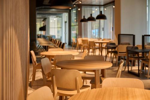 a row of tables and chairs in a restaurant at Zleep Madrid Airport in Madrid