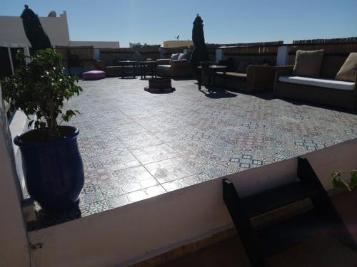 a patio with a potted plant on a roof at La colina House taghazout in Taghazout