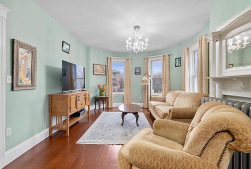 a living room with two couches and a fireplace at Bright & Spacious 3BR, Mins from Downtown, Easy to Gillette, Parking in Boston