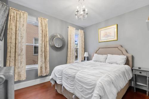 a bedroom with a bed and a window at Bright & Spacious 2Br apartment, mins from Downtown Boston, parking in Boston