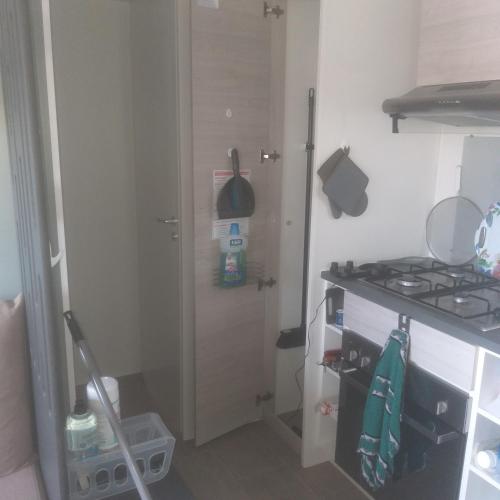a small kitchen with a stove and a sink at Domaine in Litteau