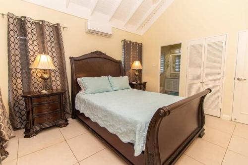 a bedroom with a large bed and two night stands at Richmond Estate With Pool House in Ocho Rios