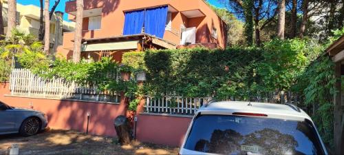 a white car parked in front of a building at La Casa del mare in Rosolina Mare